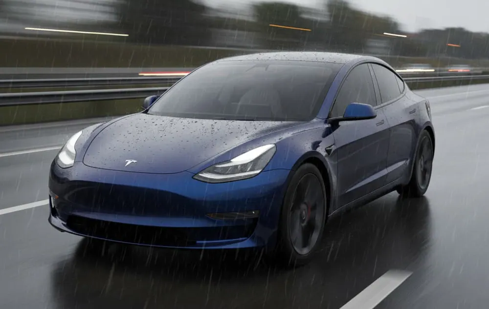 Deep blue Tesla Model 3 in a satin wrap on a wet road