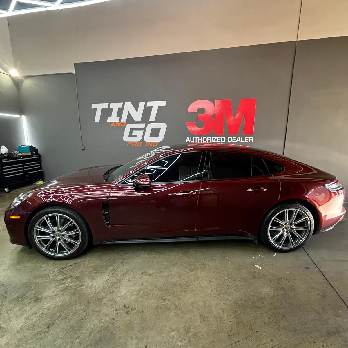 Deep red Porsche Panamera with tinted windows inside the Corona studio