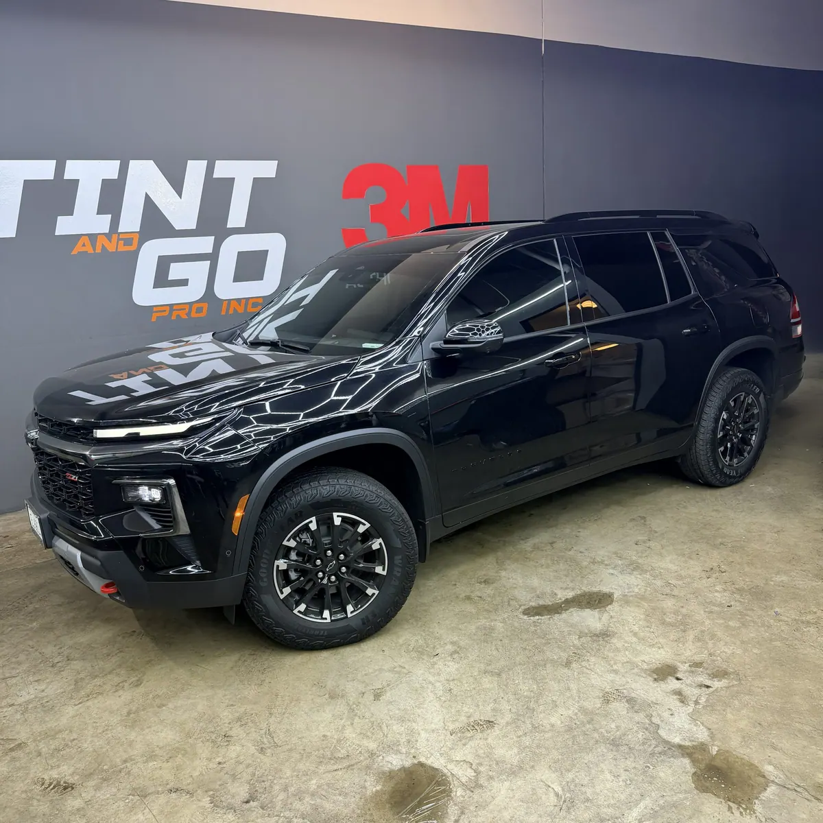 Black mid-size SUV with tinted glass and a gloss finish in the Corona bay