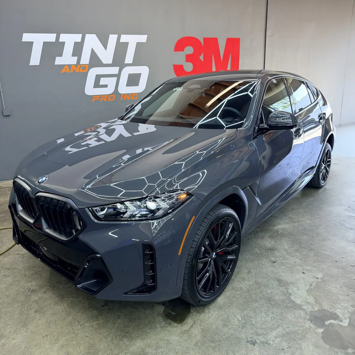 Grey BMW X6 with a deep gloss finish inside the Tint & Go Pro bay